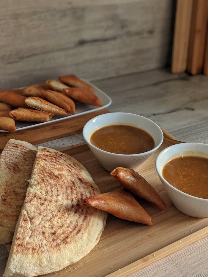Still Life with a Soup and Flatbread on Wooden Cutting Board